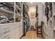 Large walk-in closet with built-in shelves and hanging rods provides ample storage at 4329 Barletta Ct, Wesley Chapel, FL 33543