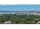 Expansive aerial view showcasing lush green trees with building complexes and a view of the ocean in the background at 4727 17Th S Ave, St Petersburg, FL 33711