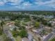 An elevated view displays the residence amidst a tree-lined neighborhood with a glimpse of the ocean at 4727 17Th S Ave, St Petersburg, FL 33711