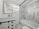 Beautifully renovated bathroom features a marble tile accent wall, tub, and vanity at 4727 17Th S Ave, St Petersburg, FL 33711