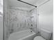 Bathroom featuring a white marble tiled shower and matching toilet at 4727 17Th S Ave, St Petersburg, FL 33711