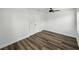 Bedroom with new flooring, white walls, ceiling fan, and natural light at 4727 17Th S Ave, St Petersburg, FL 33711
