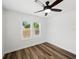 Bright bedroom featuring dark wood-look floors, and a ceiling fan at 4727 17Th S Ave, St Petersburg, FL 33711