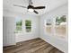 Bright bedroom featuring dark wood-look floors, and multiple windows at 4727 17Th S Ave, St Petersburg, FL 33711