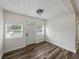 Bright entryway featuring wood-look flooring, white walls, a modern ceiling light, and windows at 4727 17Th S Ave, St Petersburg, FL 33711