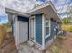 Back exterior of blue home with two doors and white trim at 4727 17Th S Ave, St Petersburg, FL 33711