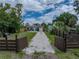 A charming home with a long gravel driveway, fenced yard, and vibrant landscaping at 4727 17Th S Ave, St Petersburg, FL 33711