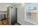Kitchen area with stainless steel refrigerator and bright window with privacy blinds at 4727 17Th S Ave, St Petersburg, FL 33711