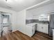 Cozy kitchen showcasing white cabinets, gray backsplash, and stainless steel refrigerator at 4727 17Th S Ave, St Petersburg, FL 33711
