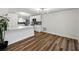 Bright kitchen with white cabinetry, stylish backsplash, and wood-look flooring at 4727 17Th S Ave, St Petersburg, FL 33711