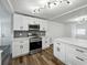 Modern kitchen featuring white cabinets, stainless steel appliances, and quartz countertops at 4727 17Th S Ave, St Petersburg, FL 33711