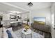 Bright, open-concept living room flowing into dining area and kitchen; features modern furnishings and finishes at 4727 17Th S Ave, St Petersburg, FL 33711