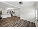 Open-concept living area featuring wood-look flooring, white walls, and adjacent kitchen space at 4727 17Th S Ave, St Petersburg, FL 33711