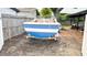 View of a boat on a trailer in a backyard with brick-paved patio and fence, great for boat owners at 4735 W Oklahoma Ave, Tampa, FL 33616