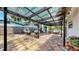 Inviting backyard with brick patio featuring a fire pit, covered pergola, and comfortable seating, perfect for outdoor living at 4735 W Oklahoma Ave, Tampa, FL 33616