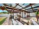 Expansive brick patio under a pergola, with lounge seating, dining area, and manicured lawn, ideal for outdoor relaxation and gatherings at 4735 W Oklahoma Ave, Tampa, FL 33616