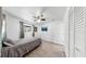 Cozy bedroom showcasing a twin bed, wood-look flooring, complemented by bright natural light and a ceiling fan at 4735 W Oklahoma Ave, Tampa, FL 33616