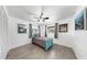 Inviting bedroom featuring a twin bed, natural light from two windows, complemented by a modern ceiling fan at 4735 W Oklahoma Ave, Tampa, FL 33616