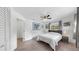 Inviting bedroom features natural light, ceiling fan, closet, and wood-look tile flooring at 4735 W Oklahoma Ave, Tampa, FL 33616