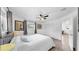 Bright bedroom with a queen bed, ceiling fan, and a closet with folding doors, all within a neutral color scheme at 4735 W Oklahoma Ave, Tampa, FL 33616