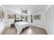Comfortable bedroom with natural light, wood-look tile floors, ceiling fan, and closet at 4735 W Oklahoma Ave, Tampa, FL 33616