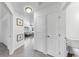 Bright hallway with modern flooring, showcasing a seamless transition to an inviting living area, enhanced by natural light at 4735 W Oklahoma Ave, Tampa, FL 33616