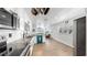 Bright kitchen offers stainless steel appliances, granite counters, white subway tile backsplash, and wood-look tile flooring at 4735 W Oklahoma Ave, Tampa, FL 33616