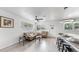 Inviting living room features natural light, wood-look tile flooring, and a comfortable seating area at 4735 W Oklahoma Ave, Tampa, FL 33616