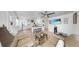 Spacious living room with comfortable seating, view to the kitchen with breakfast bar, and wood-look tile flooring at 4735 W Oklahoma Ave, Tampa, FL 33616