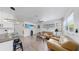 Cozy living room with comfortable seating area, bright lighting, and wood-look tile floors at 4735 W Oklahoma Ave, Tampa, FL 33616