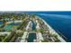 Aerial view of a waterfront community with boat docks, tennis courts, pool, and a clubhouse at 5075 Starfish Se Dr # A, St Petersburg, FL 33705