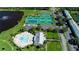 Aerial view of community tennis courts, pickleball courts, a clubhouse and a pool at 5075 Starfish Se Dr # A, St Petersburg, FL 33705