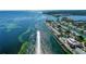 Expansive aerial shot of homes with boat docks, waterfront views, and a boat cruising on the open water at 5075 Starfish Se Dr # A, St Petersburg, FL 33705