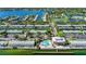 Aerial view showcasing waterfront condos, tennis courts, and a pool overlooking the ocean at 5075 Starfish Se Dr # A, St Petersburg, FL 33705