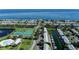 Breathtaking aerial shot of waterfront homes, tennis courts, a canal with boat docks, and a shimmering bay at 5075 Starfish Se Dr # A, St Petersburg, FL 33705