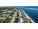 Picturesque aerial view features waterfront homes with boat docks, a community pool, and stunning bay views at 5075 Starfish Se Dr # A, St Petersburg, FL 33705