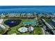 Stunning aerial view of waterfront homes, tennis courts, and a pool, set against the backdrop of a beautiful bay at 5075 Starfish Se Dr # A, St Petersburg, FL 33705