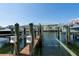 View from dock featuring boat slips with power hookups with waterfront condo in background at 5075 Starfish Se Dr # A, St Petersburg, FL 33705