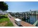 Dock view featuring boat slip with a boat lift and a storage box in a waterfront community at 5075 Starfish Se Dr # A, St Petersburg, FL 33705