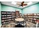 Community library featuring ample seating, well-stocked shelves, and overhead lighting at 5075 Starfish Se Dr # A, St Petersburg, FL 33705