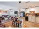 Inviting living room with bar seating opening into a kitchen with granite countertops and updated cabinets at 5075 Starfish Se Dr # A, St Petersburg, FL 33705