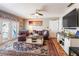 Cozy living room featuring hardwood floors, comfortable seating, and sliding glass doors at 5075 Starfish Se Dr # A, St Petersburg, FL 33705