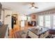 Inviting living room with hardwood floors, leather seating, and view of the kitchen at 5075 Starfish Se Dr # A, St Petersburg, FL 33705