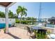 Waterfront patio with brick pavers, comfortable seating, and nearby boat dock at 5075 Starfish Se Dr # A, St Petersburg, FL 33705