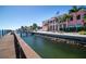 Scenic water view from the community dock area with lush landscaping and architecture at 5075 Starfish Se Dr # A, St Petersburg, FL 33705