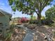 Spacious backyard with lush garden, stone walkway, mature trees offering a private outdoor space at 544 80Th N Ave, St Petersburg, FL 33702