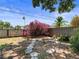 Landscaped backyard featuring a beautiful bougainvillea, stepping stones, and wood privacy fence at 544 80Th N Ave, St Petersburg, FL 33702