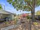 Wide view of the backyard area featuring a patio and garden area with mature shade trees at 544 80Th N Ave, St Petersburg, FL 33702