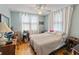Cozy bedroom featuring wood floors, ceiling fan, and ample natural light at 544 80Th N Ave, St Petersburg, FL 33702