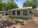 A single-story home featuring multiple windows for ample natural light and lush landscaping at 544 80Th N Ave, St Petersburg, FL 33702